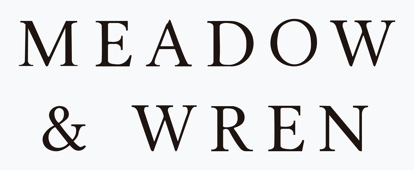 The Meadow and Wren stacked square lockup — wordmark on two lines above the botanical sprig