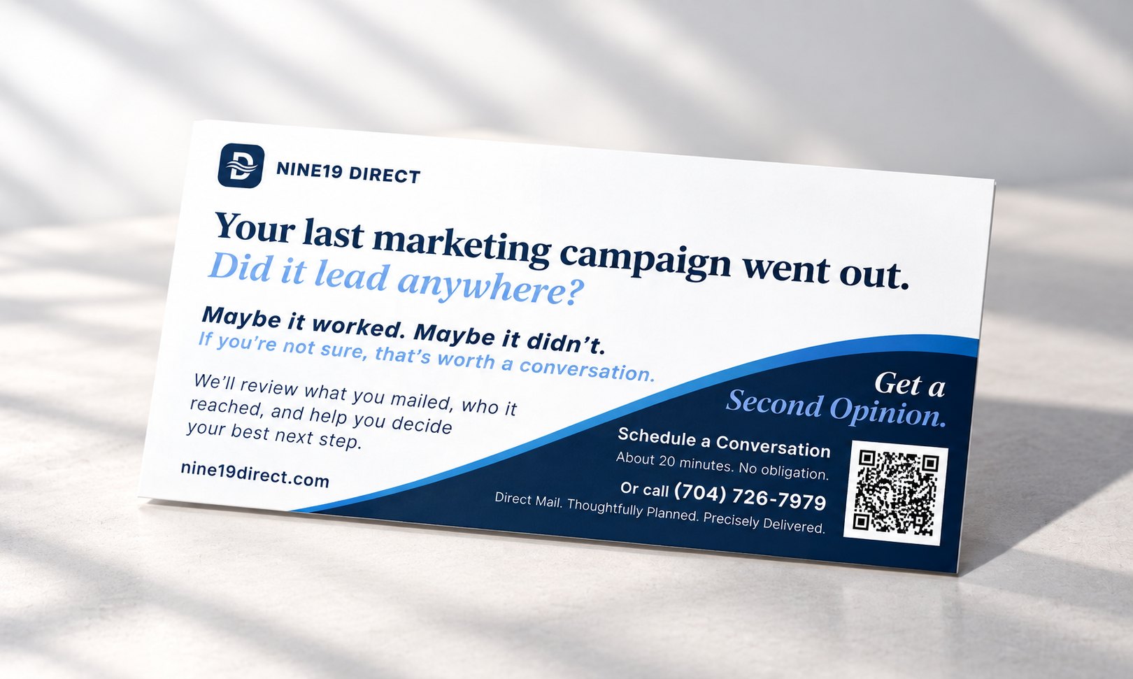The message side of the Nine19 Direct card standing on a tabletop in soft window light