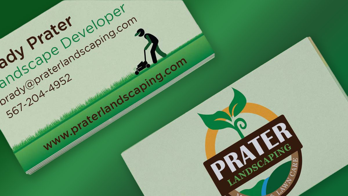 Prater Landscaping business cards on a grass background — full mark on one face, contact details for Brady Prater on the other